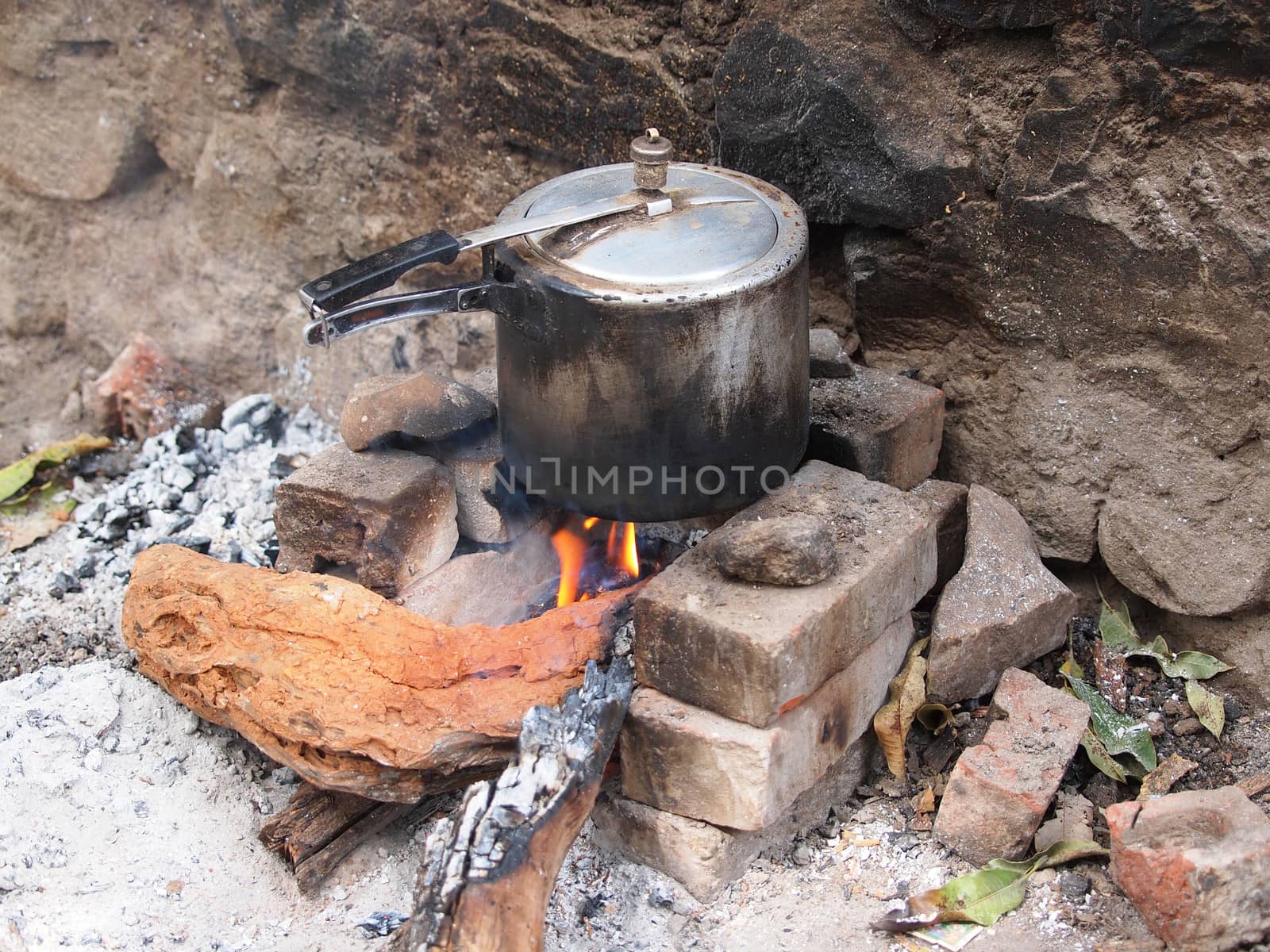 cooking on open fire in  big pot     