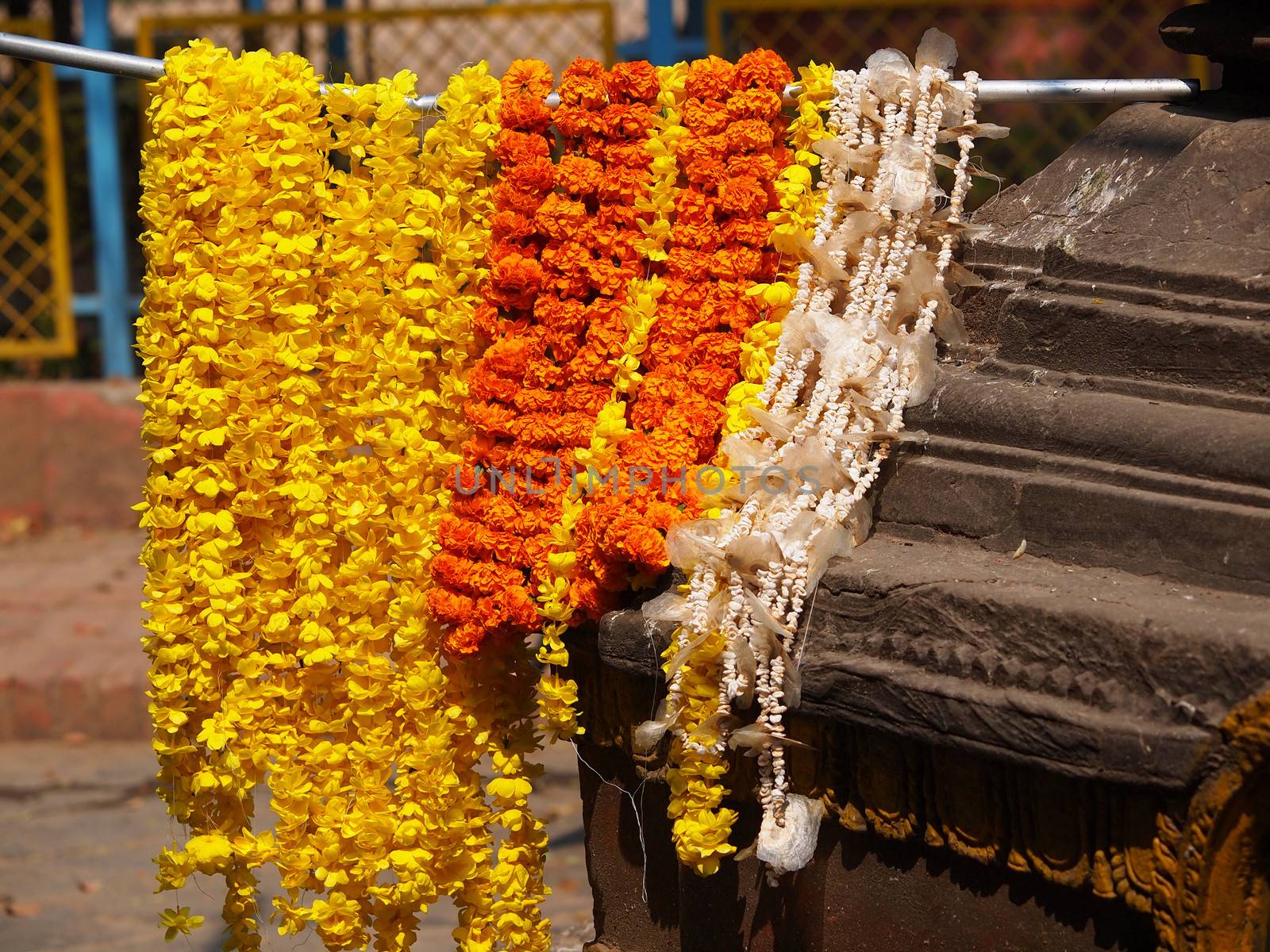 orange and yellow floral arrangement for holi festival and religious offerings in india.       