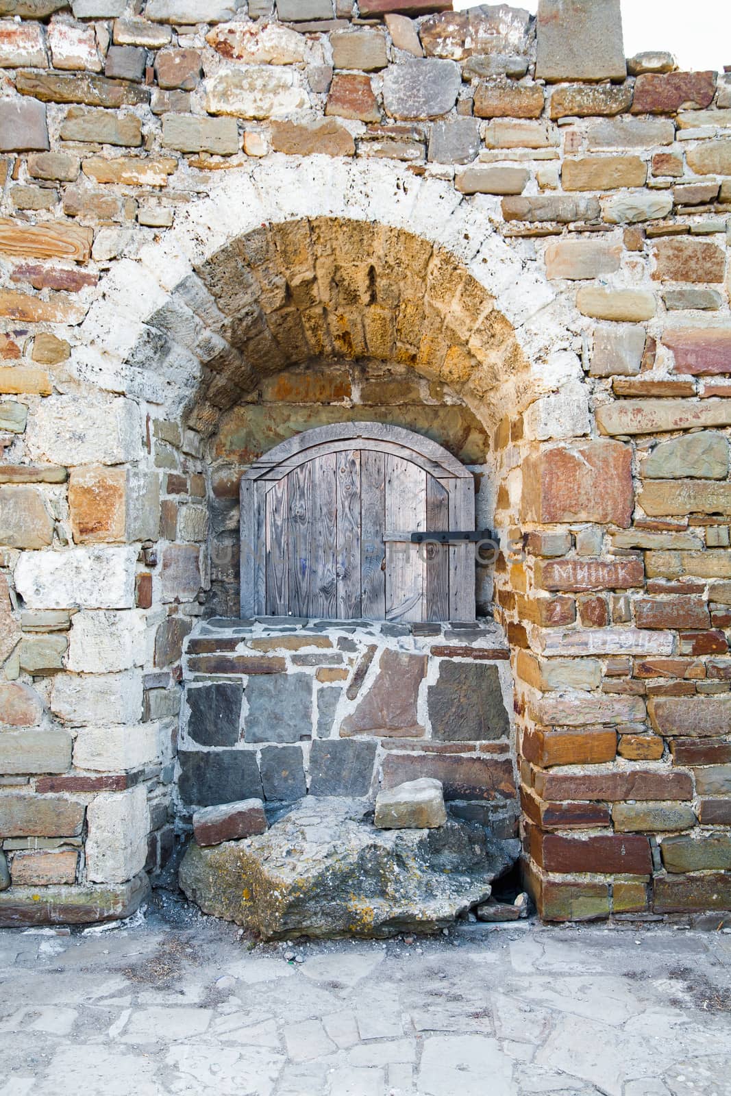 Ancient wooden window of medieval brick wall by sfinks