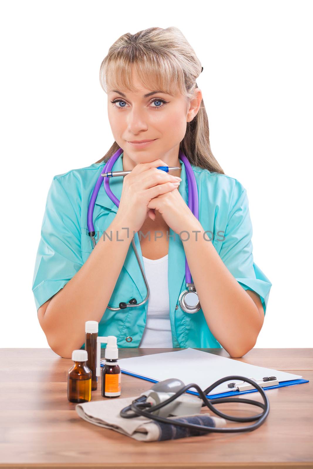 beautiful female doctor sitting at table and looking at camera by mihalec