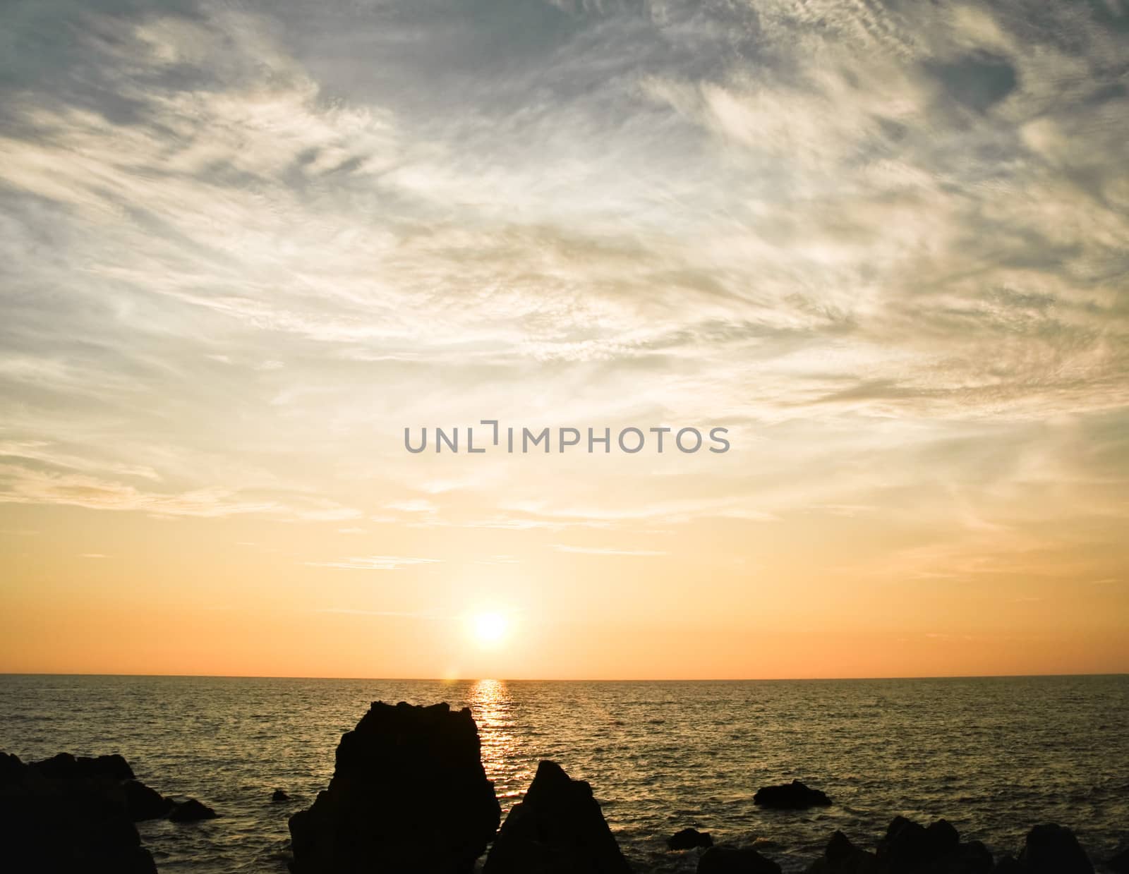 Sunset with clouds ocean and big rocks by juhku