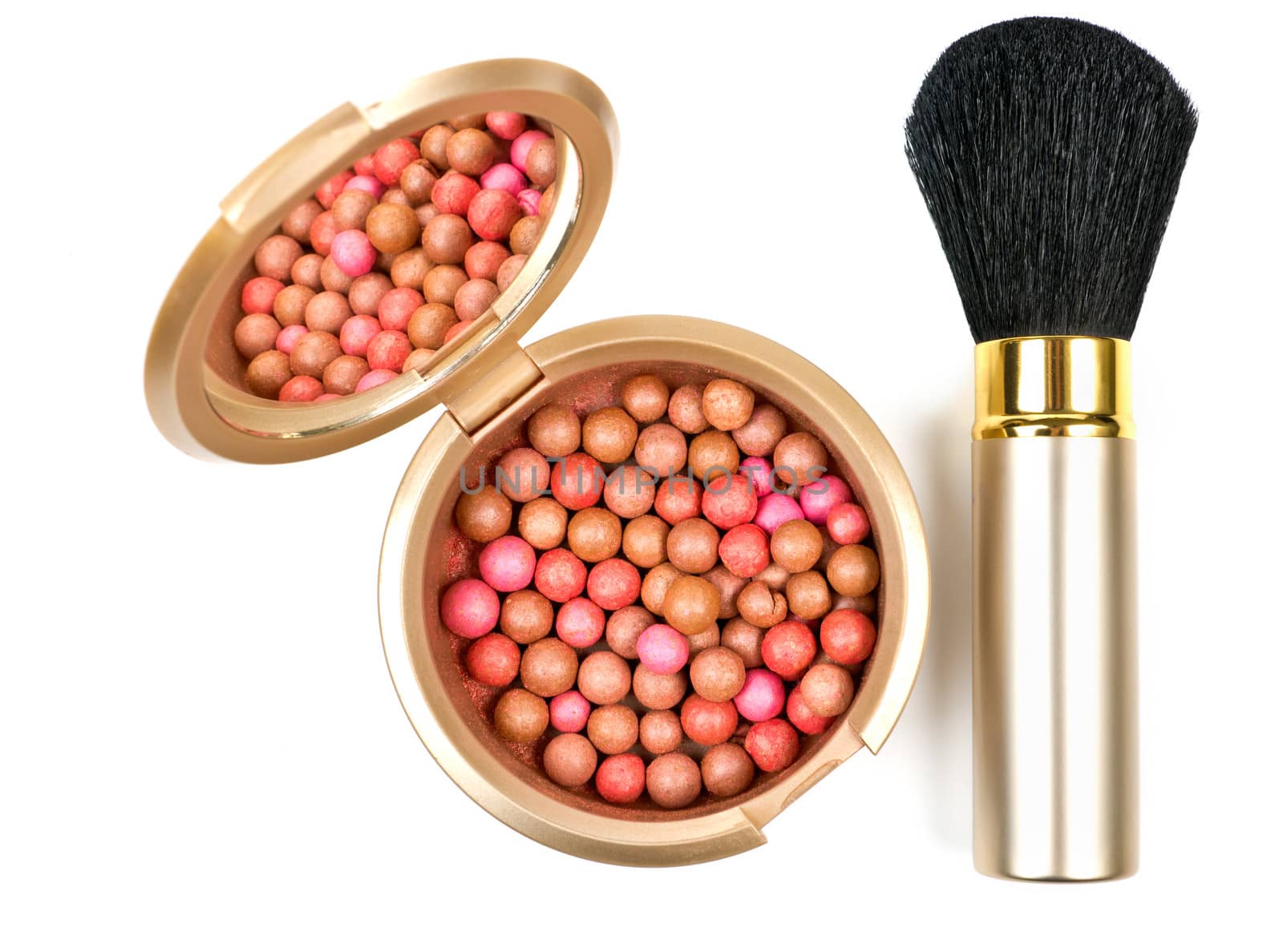 Bronzing pearls in powder box with mirror and make up brush over white
