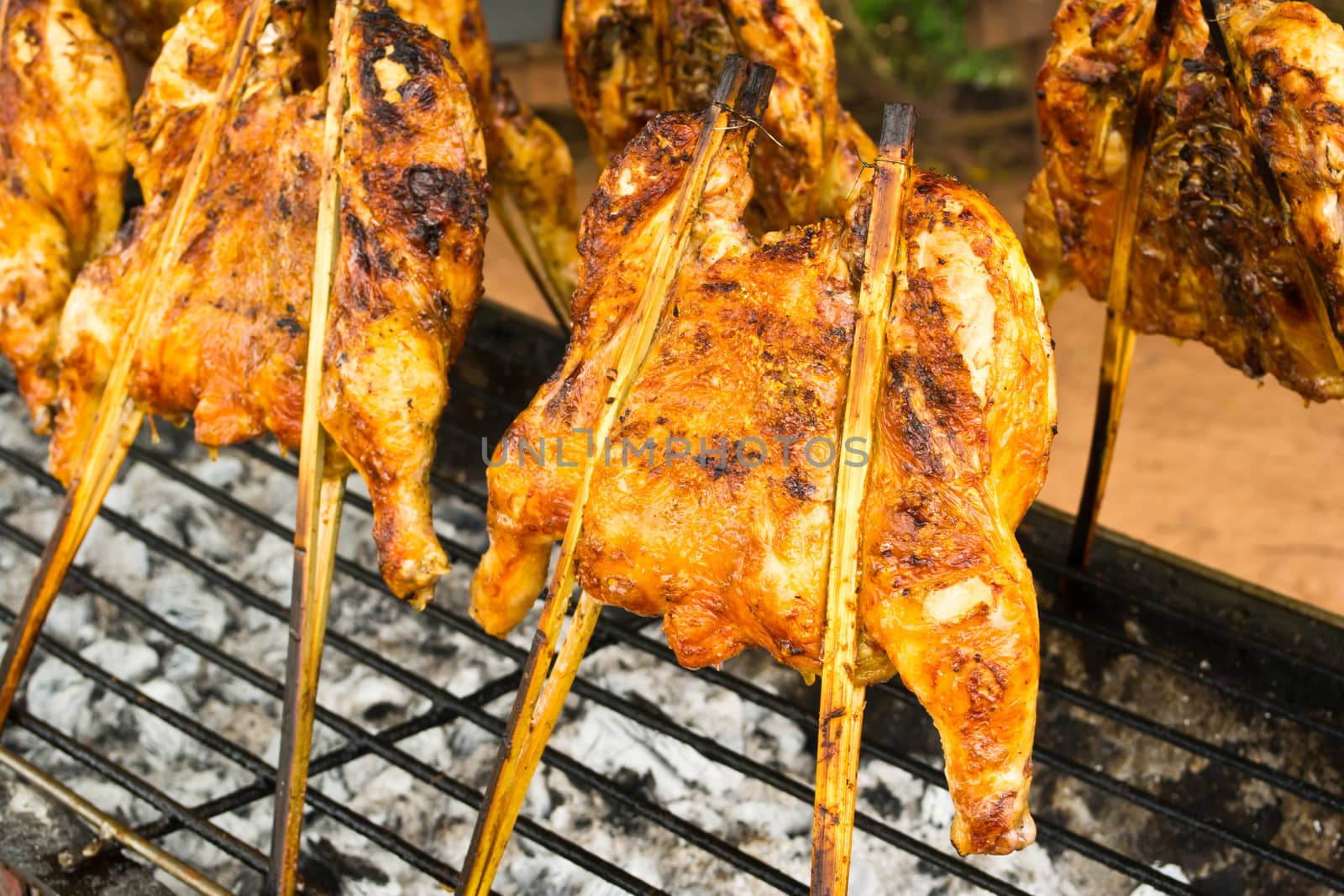 Delicious roasted chicken herb on fireplace