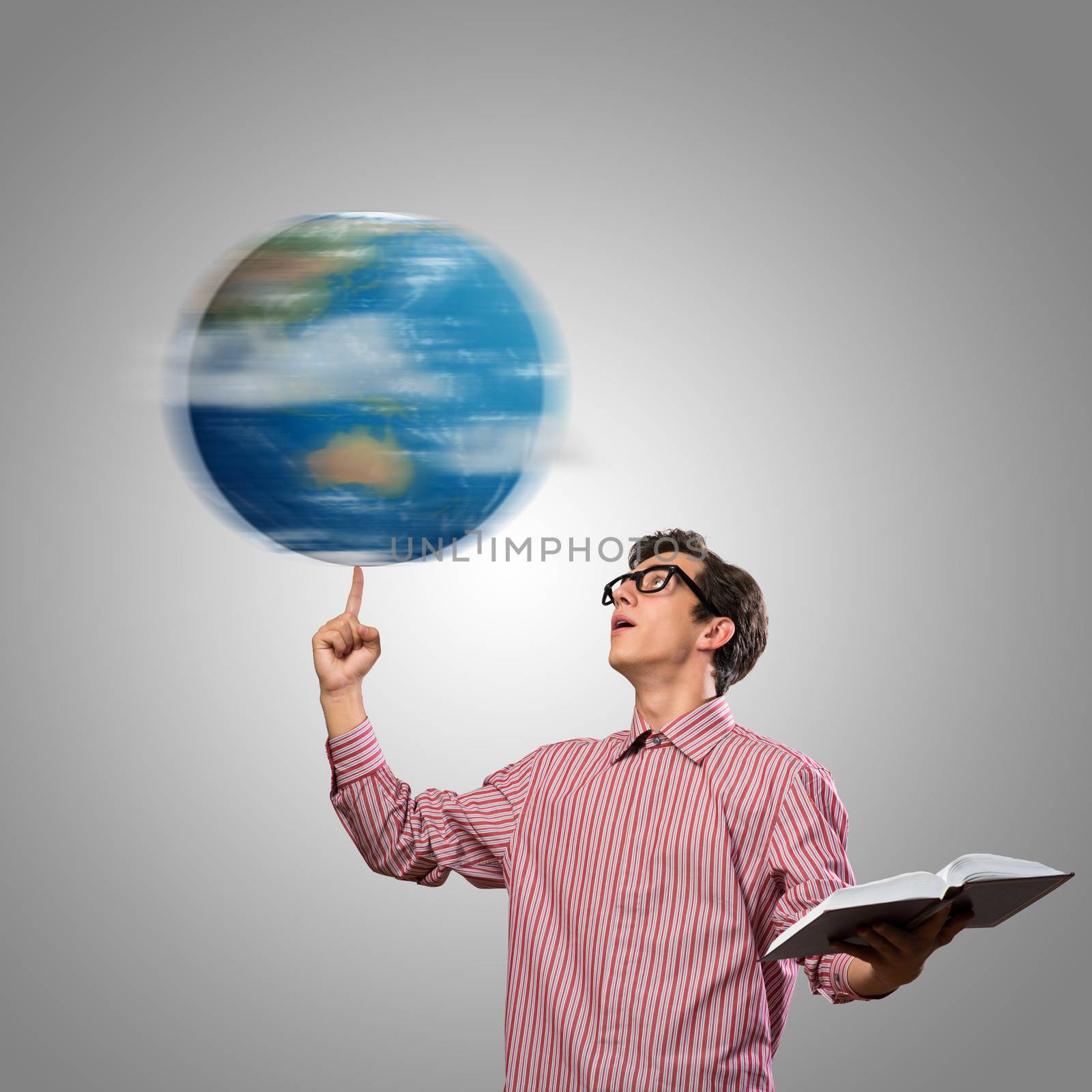 young man with a book thinks. keeps the finger symbol of the planet Earth. NASA images used