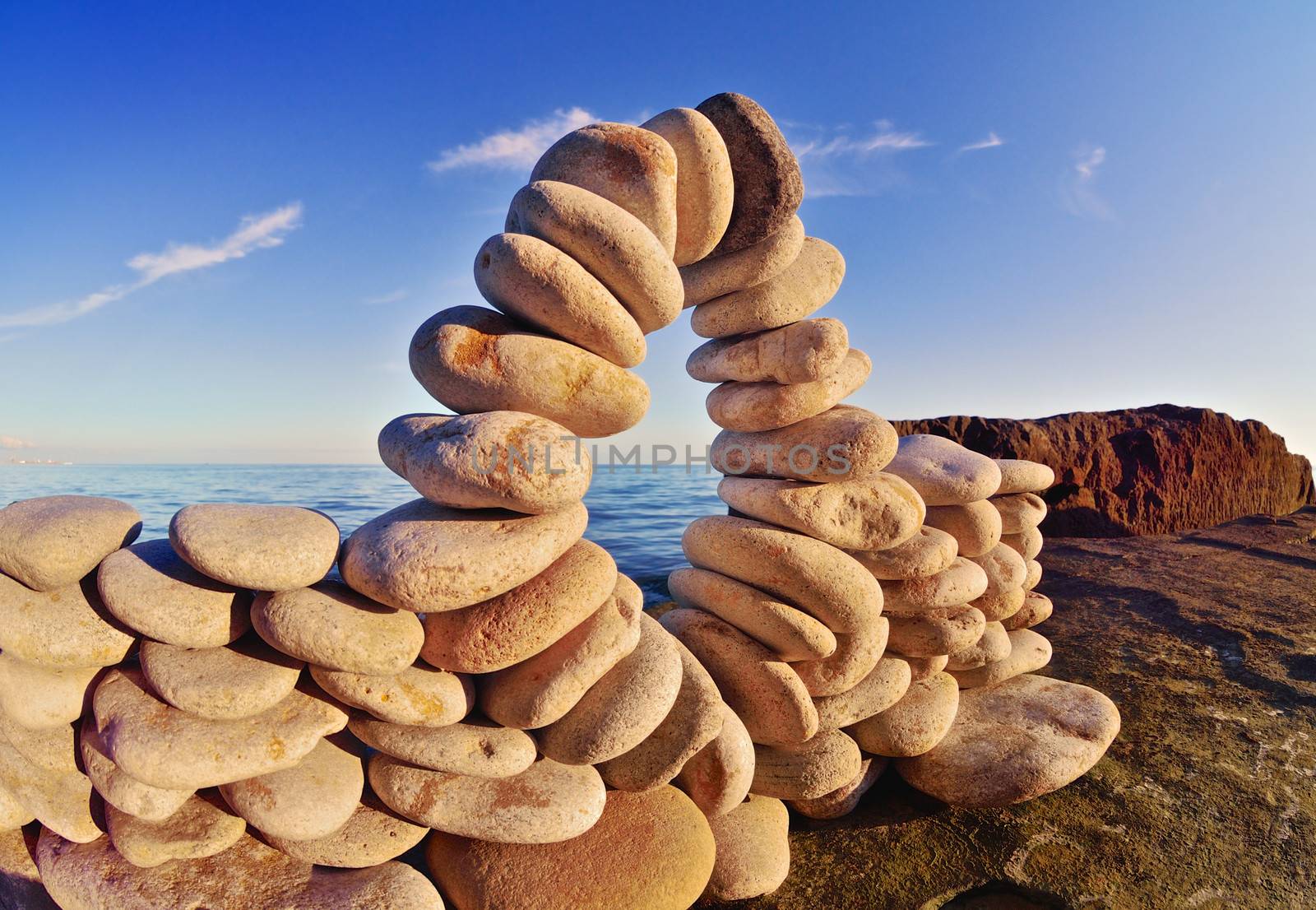 Stone arch between the pebbles on the coast