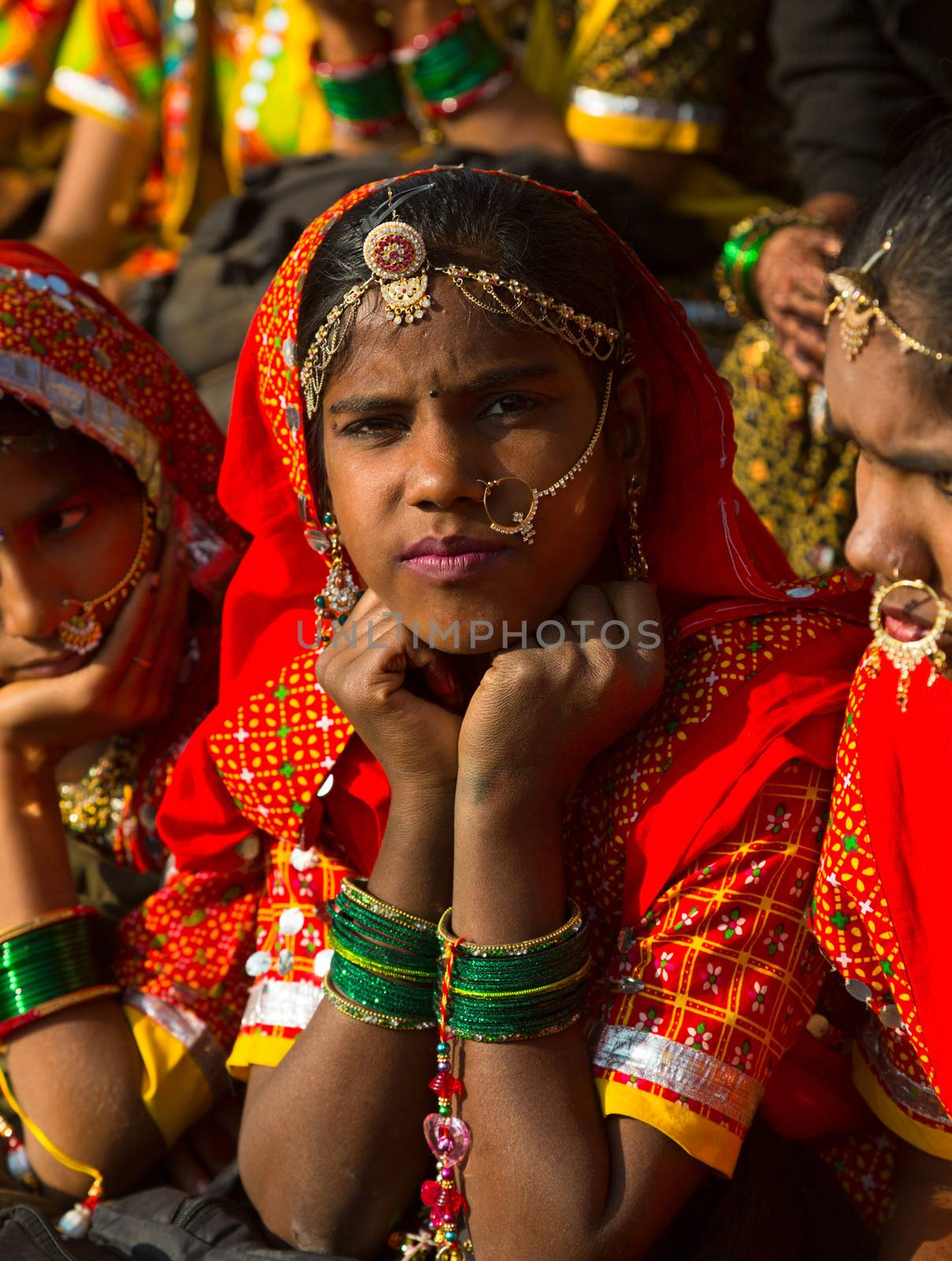 Rajasthan, India, November-21, 2012: Traditional Indian women in a rural costume looking for the camera at Pushkar camel fair, Rajasthan, India