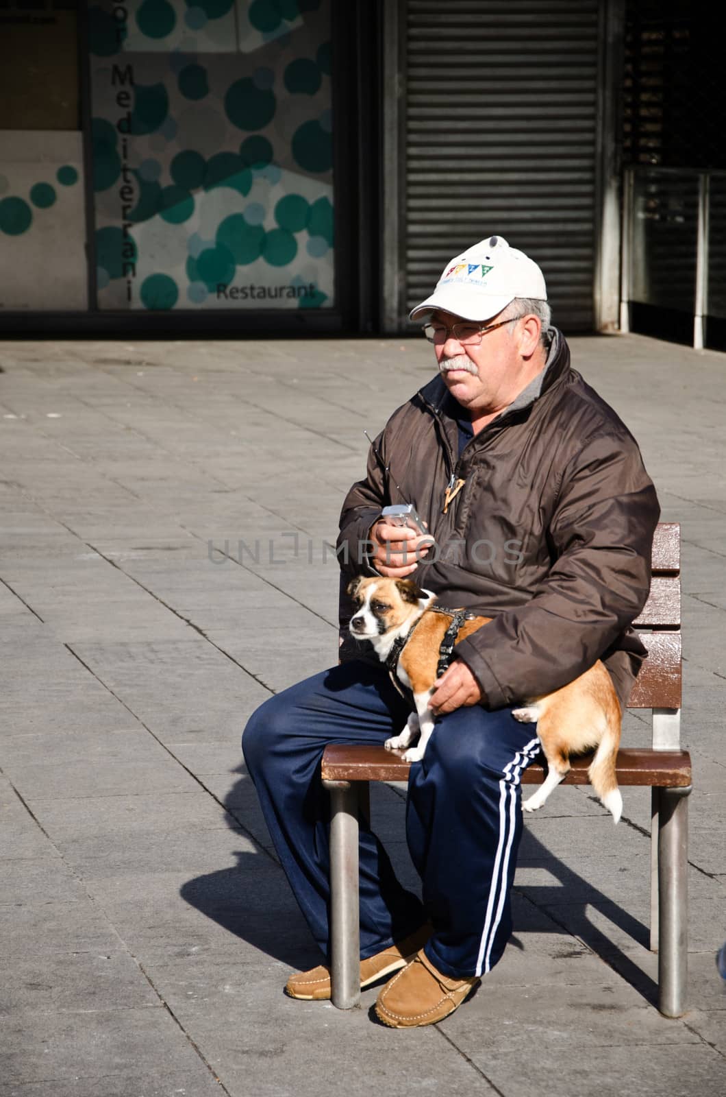 Seated man with dog.
