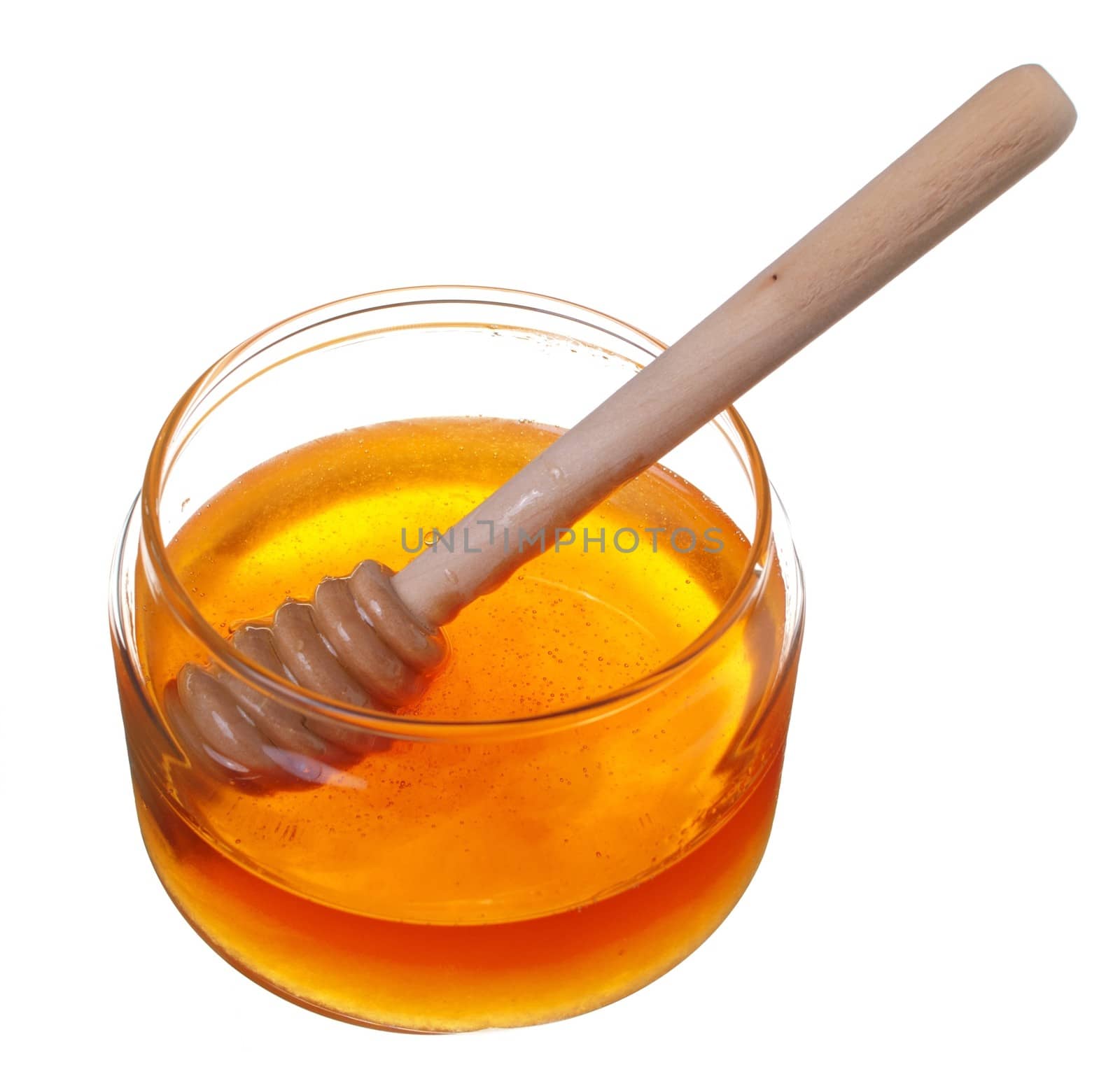 Jar of honey with wooden drizzler isolated on white background