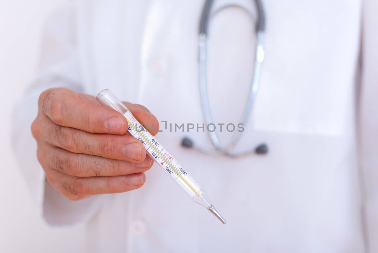 Close-up of doctor's hands showing thermometer by mitakag