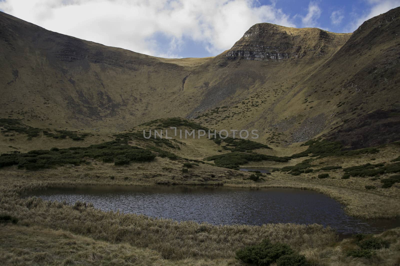 Oval lake at the foot of the mountain