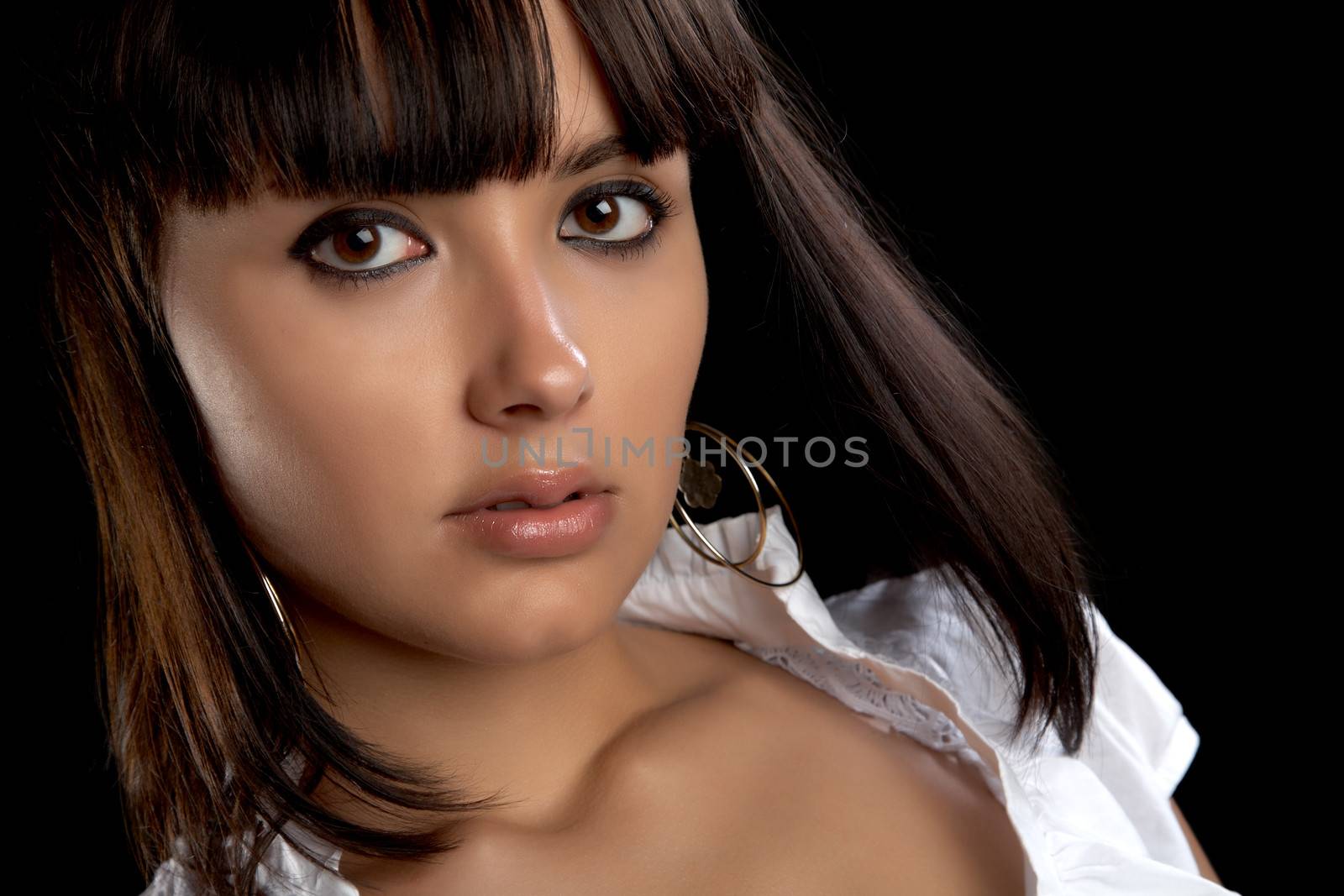 Portrait of the beautiful girl on a black background