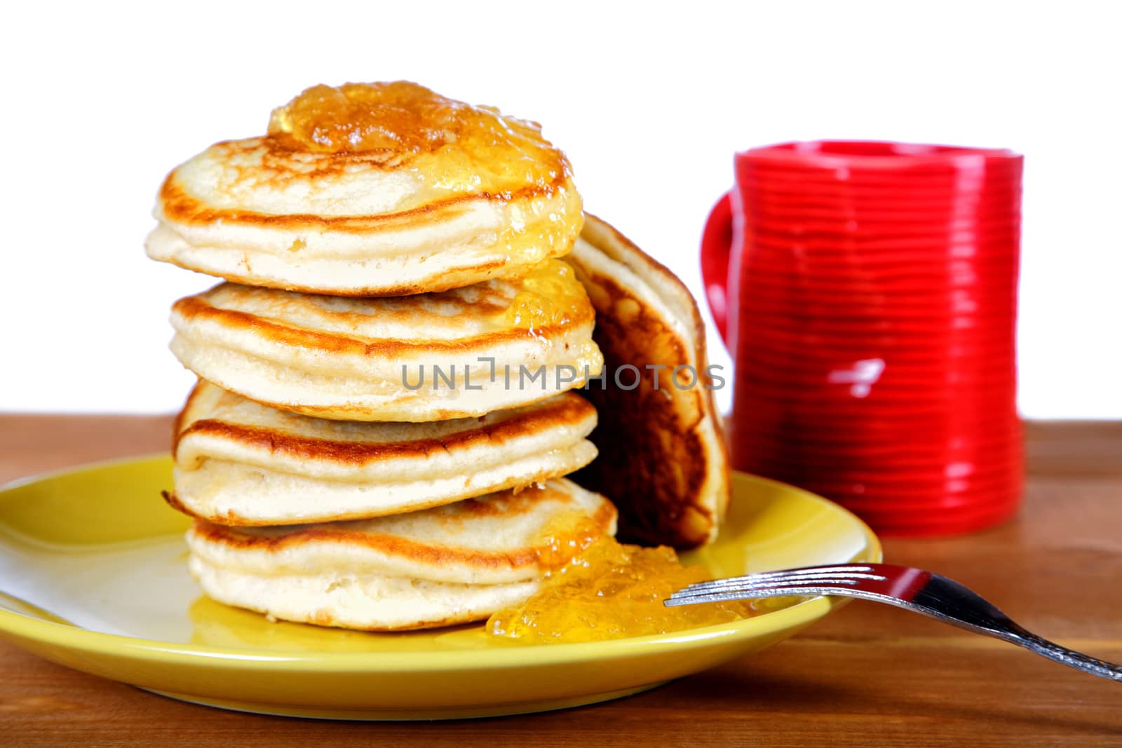 Fritters with jam and a cup on white background