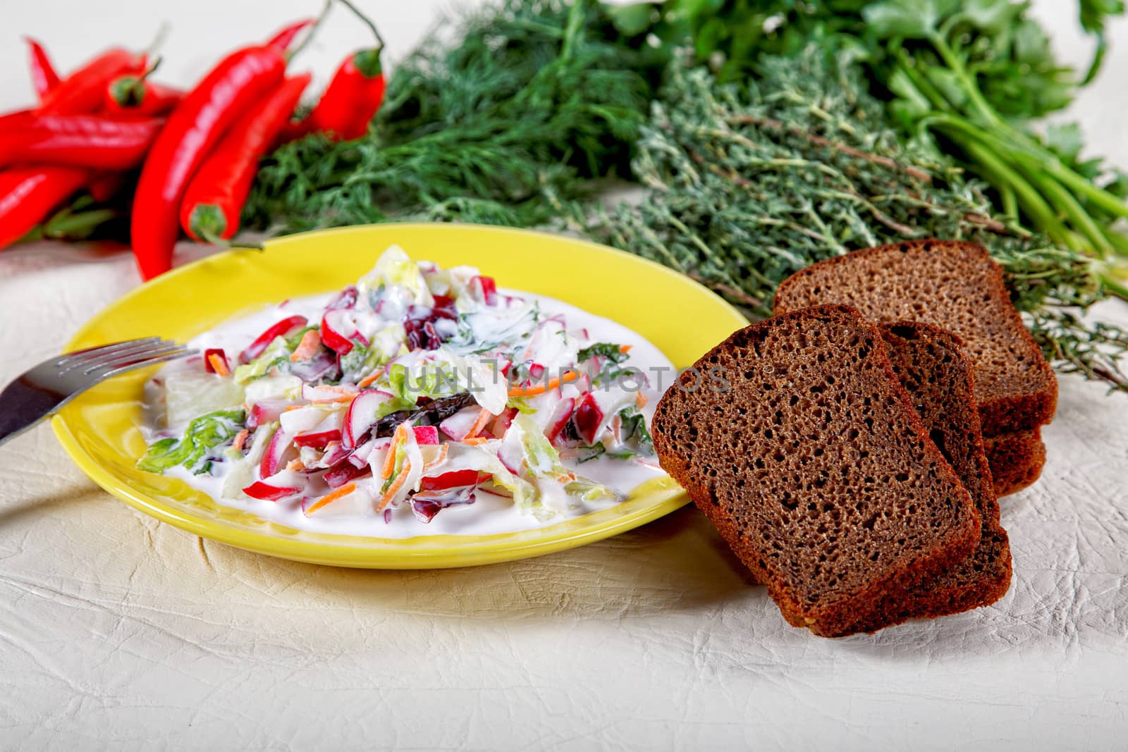 Plate of salad with black bread and spices