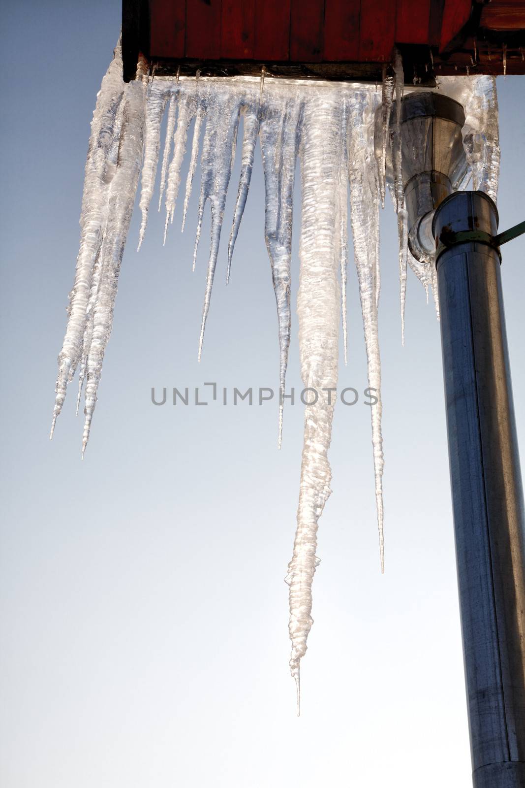 Icicles on a roof and a drainpipe