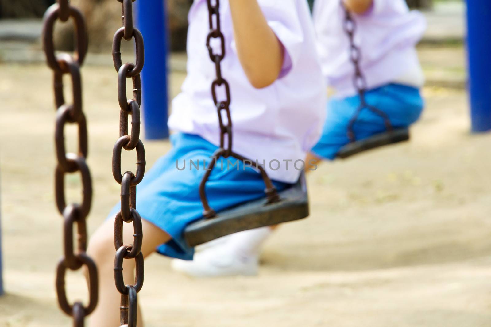 child swinging at a playground