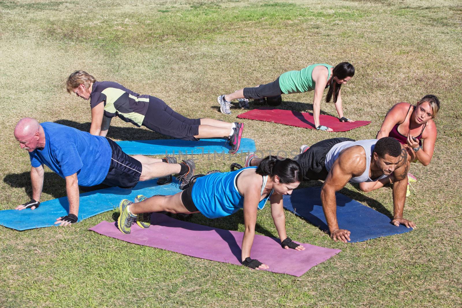 Diverse group of adults in boot camp fitness class