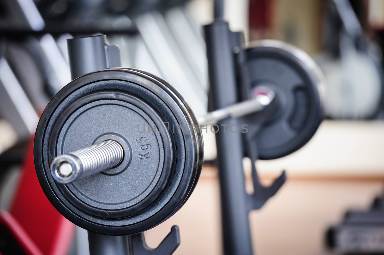 Barbell ready for workout, indoors, selective focus