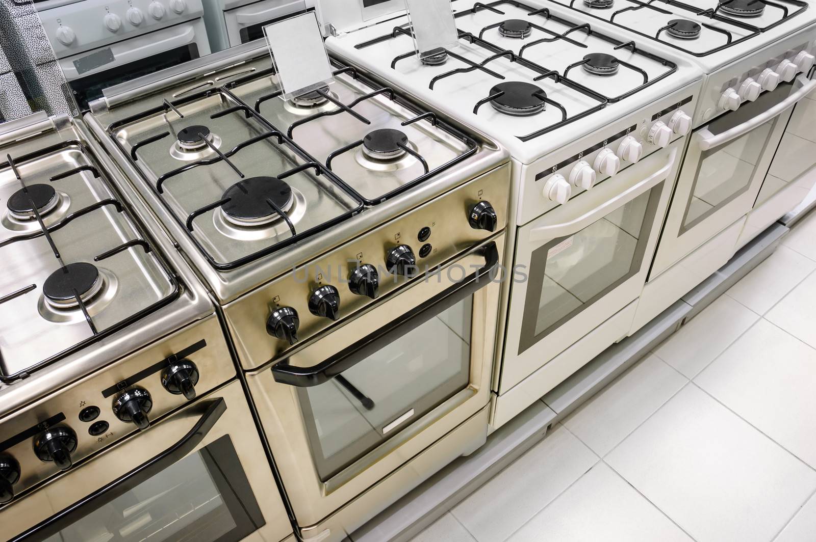 rows of gas stoves selling in home appliance store