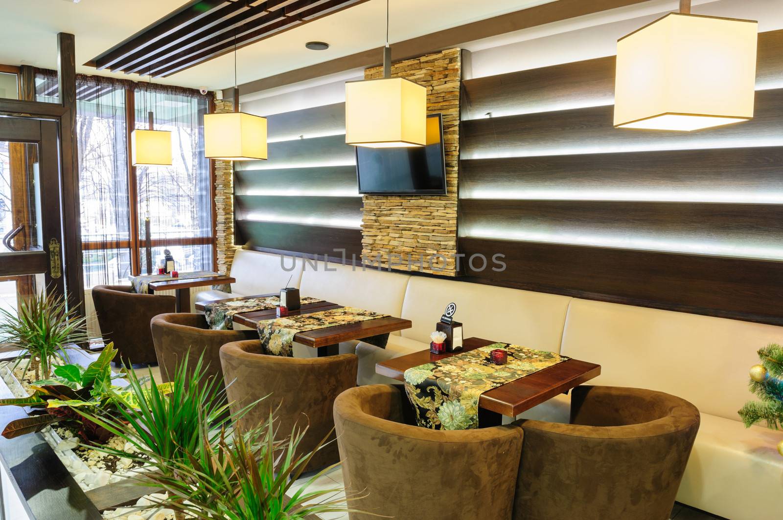 Modern restaurant interior with tables and sofas