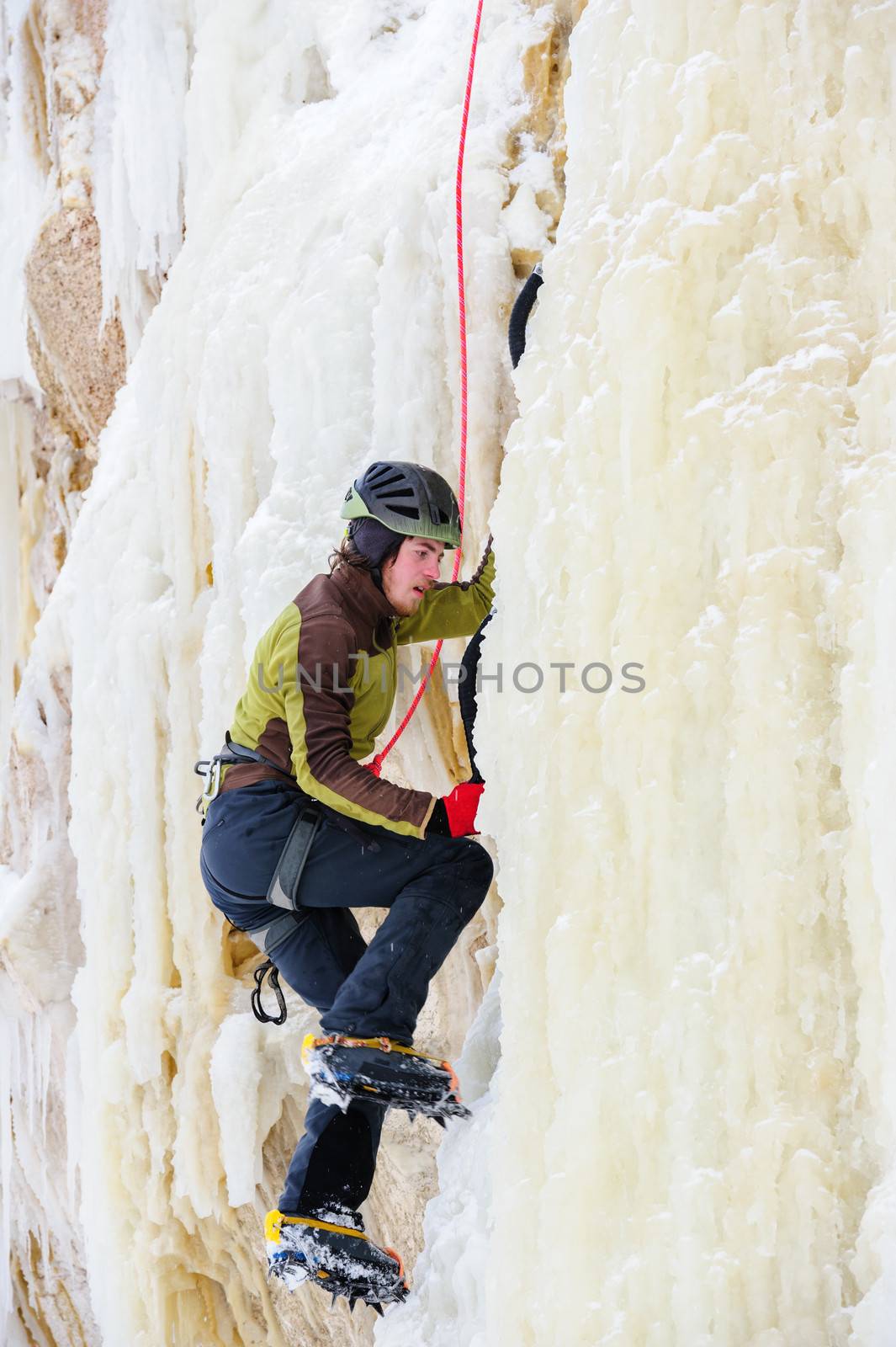 Young man climbing the ice by starush