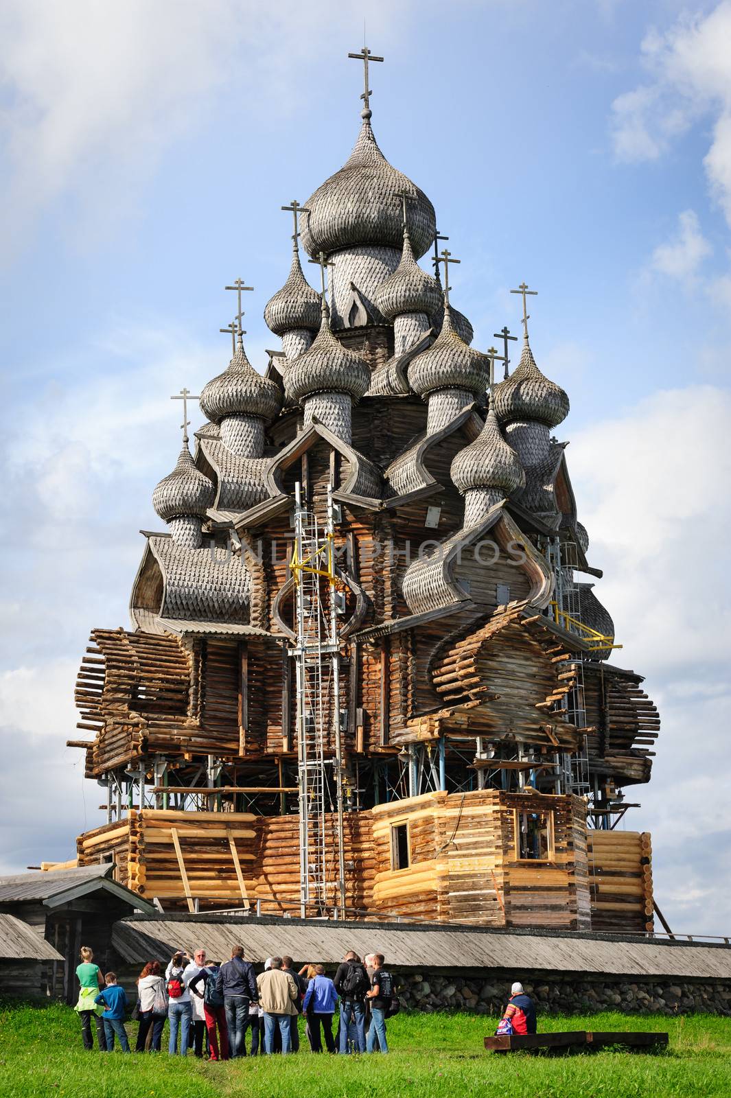 Excurtion group looking at wooden church at Kizhi under reconstr by starush