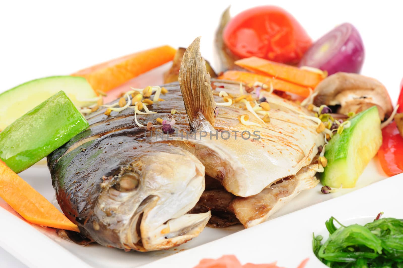 fried wish with grilled vegetables and chukka seaweed, macro closeup