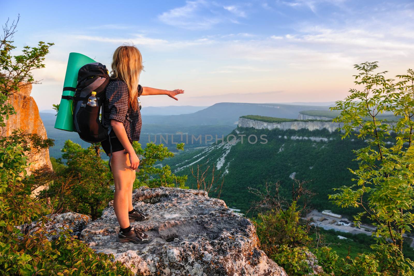 Hiking woman in rays of sunset by starush