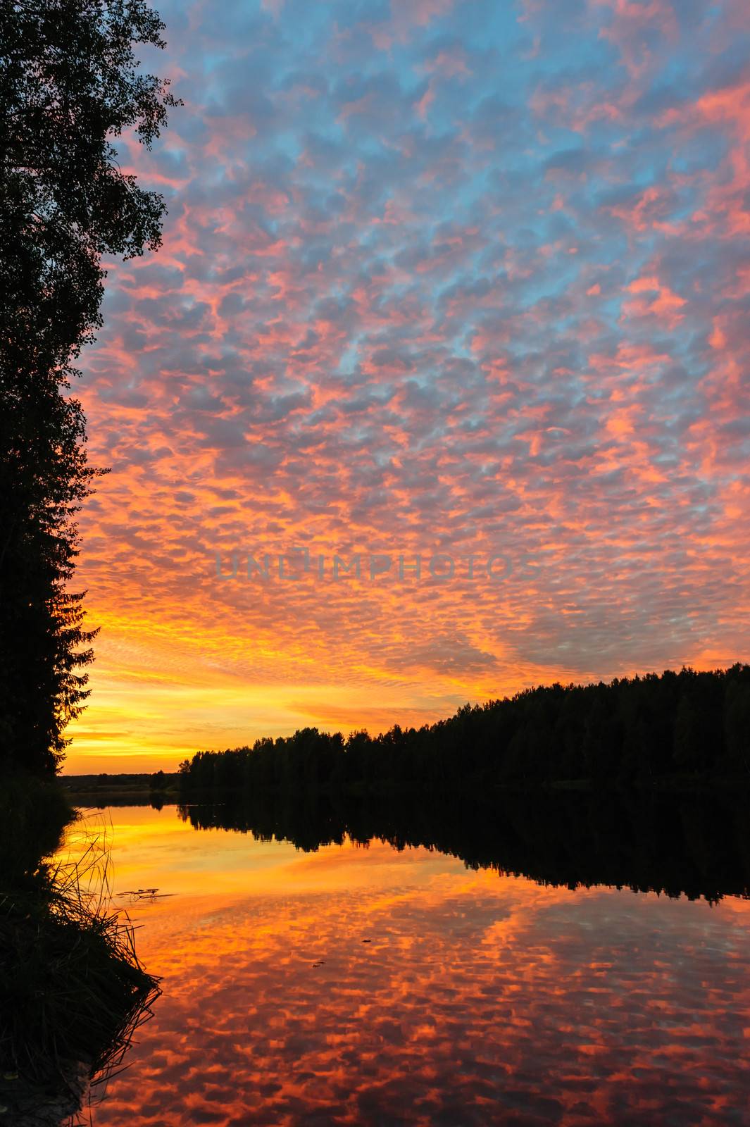 Dramatic sunset over the river in Karelia, the north of Russia