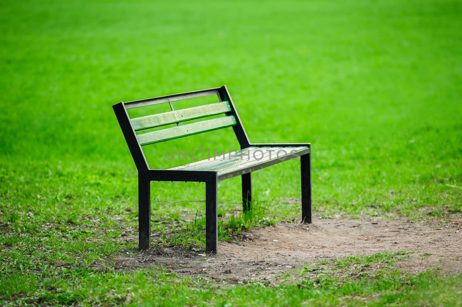 Lonely green broken bench in the park