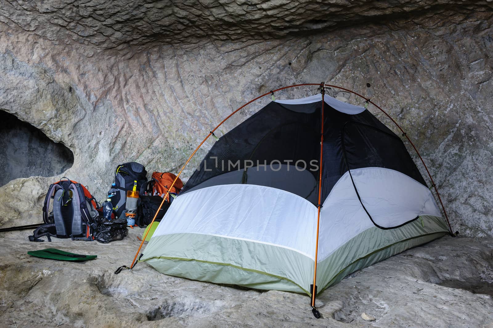 Camp, backpacks and one tent in the cave