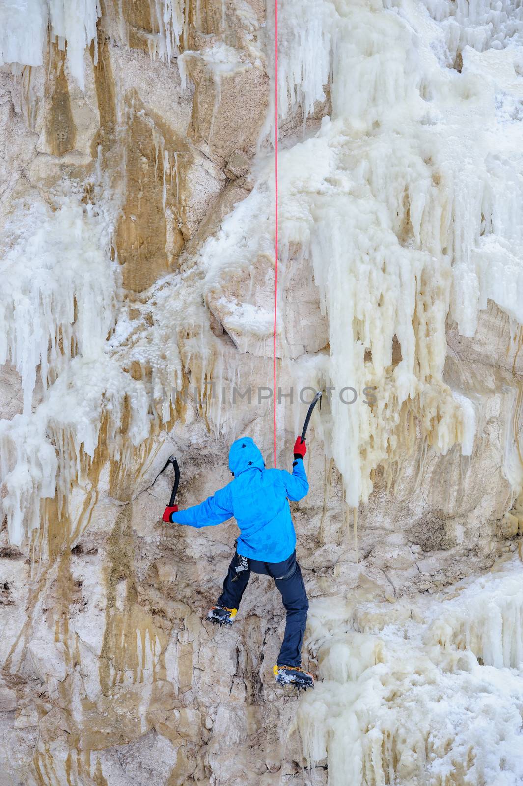 Young man climbing the ice by starush