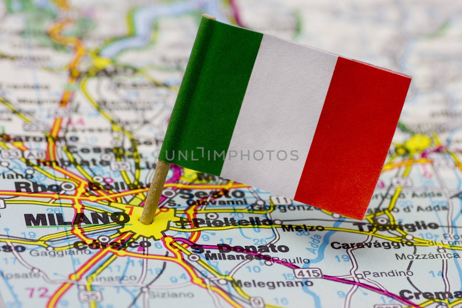 The city of Milan on a map. The Italian flag pointing in the city centre