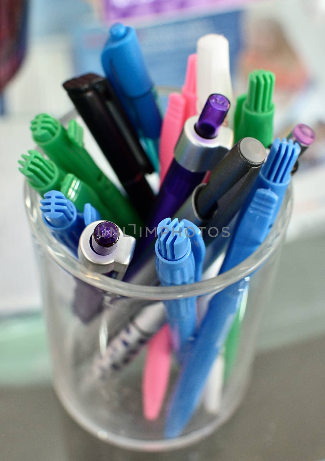 Colorful of pen in clear glass by pixbox77