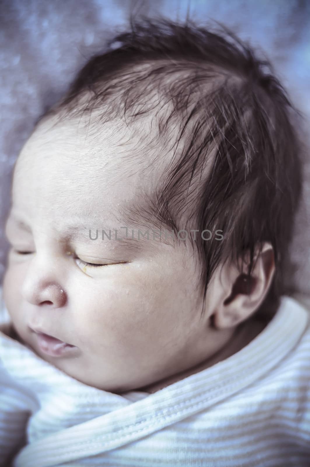 Sleep, new born baby curled up sleeping on a blanket, multiple expressions