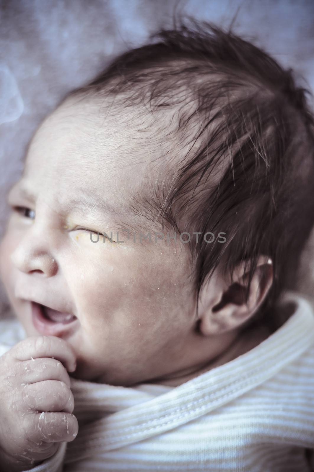 Yawn, new born baby curled up sleeping on a blanket, multiple expressions