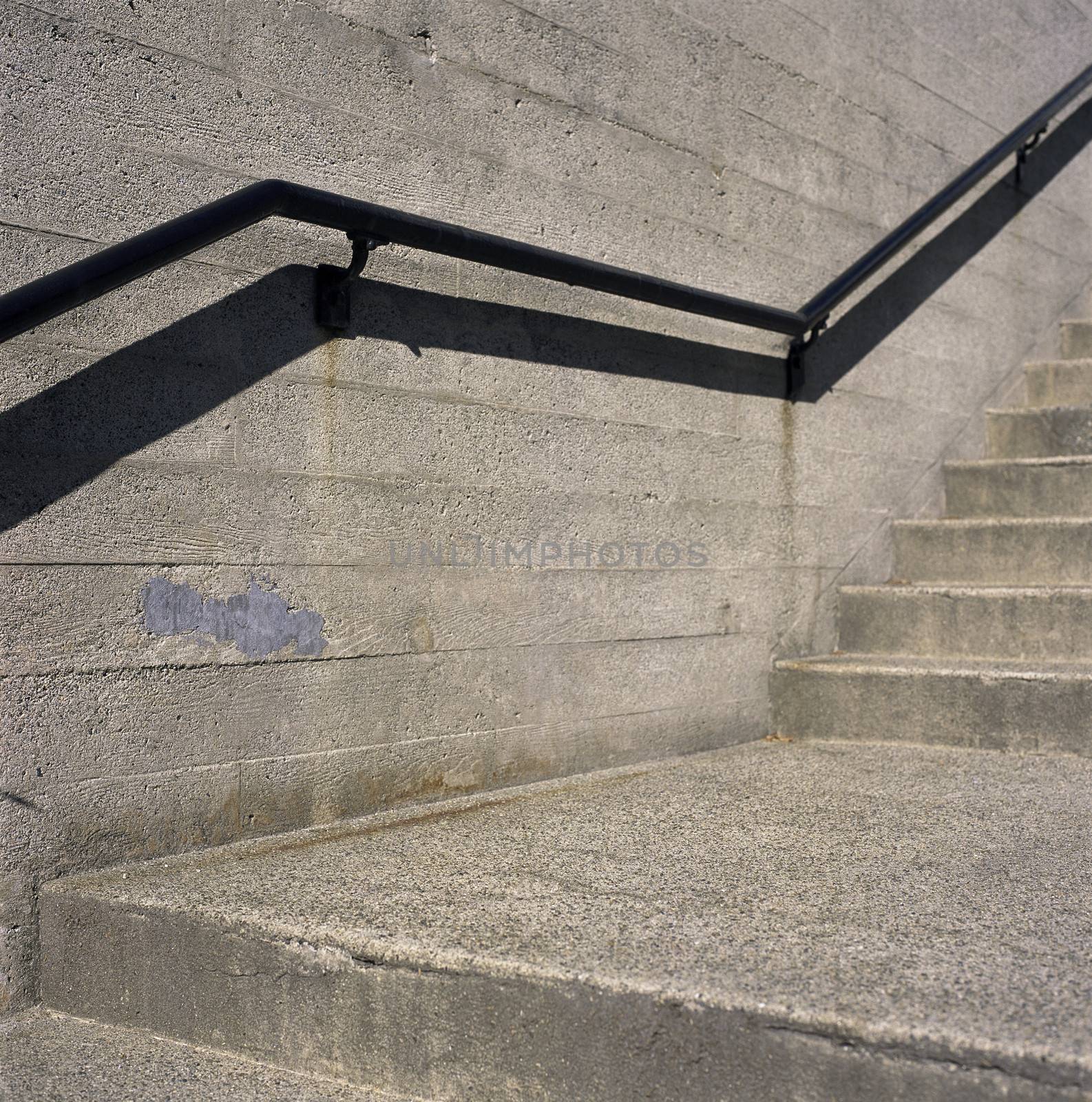 Concrete steps and iron railings with groove concrete wall