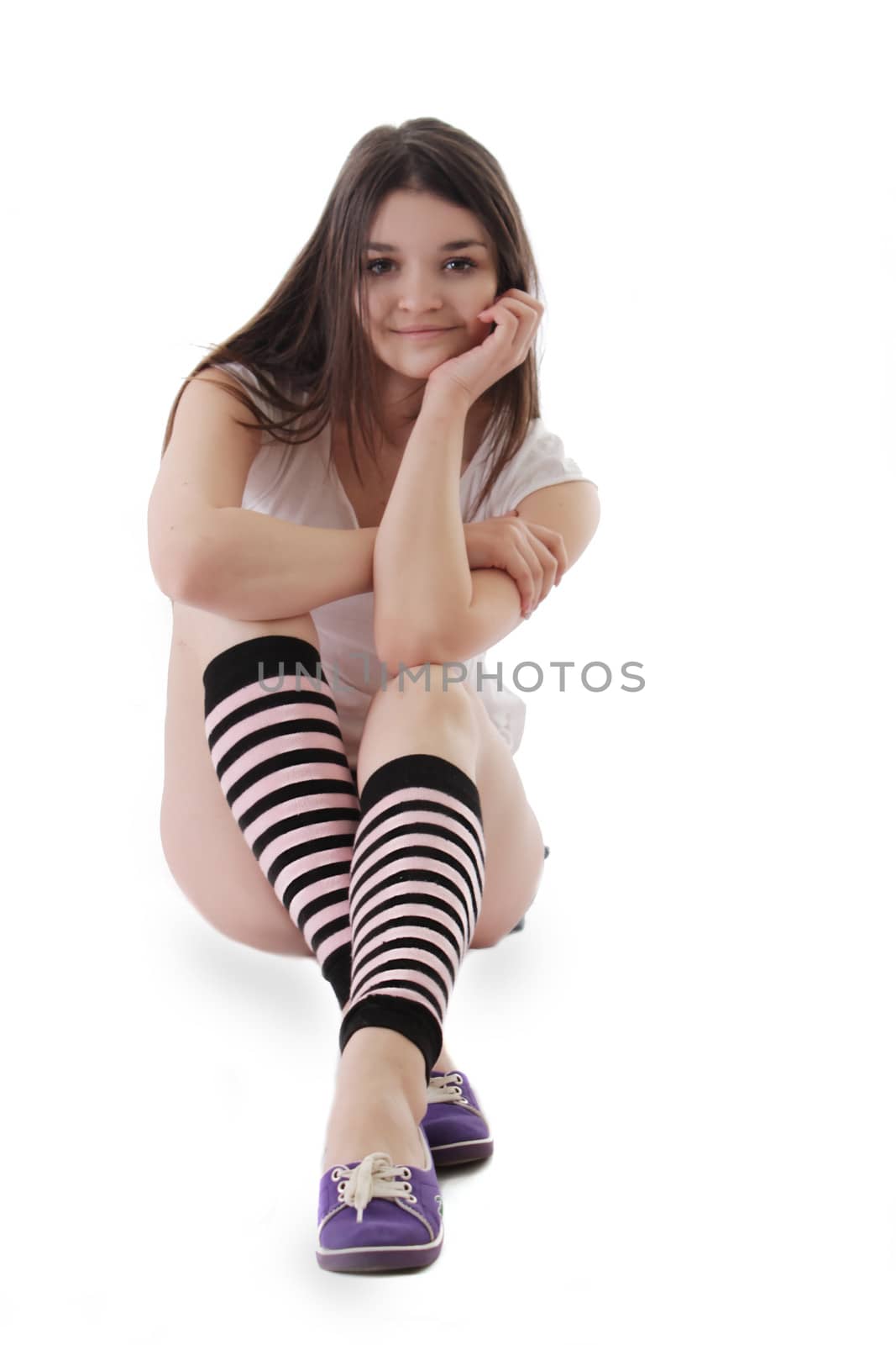 Cute teenage girl sitting isolated on white