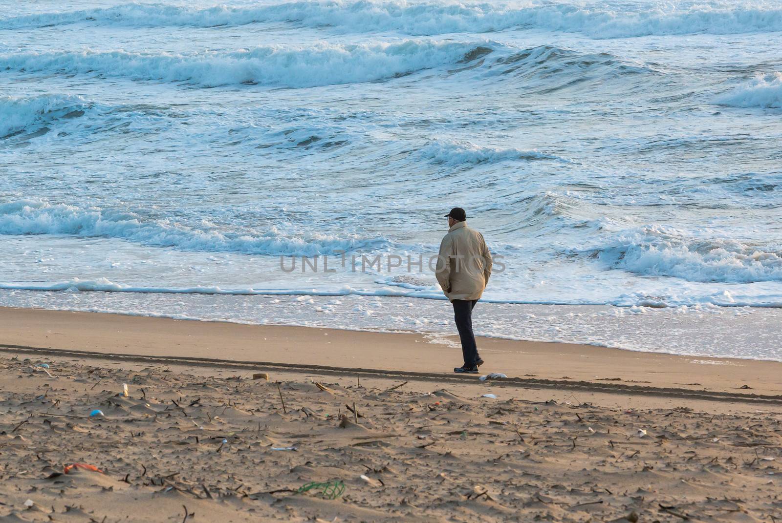 Man Walks Along Coast by Discovod