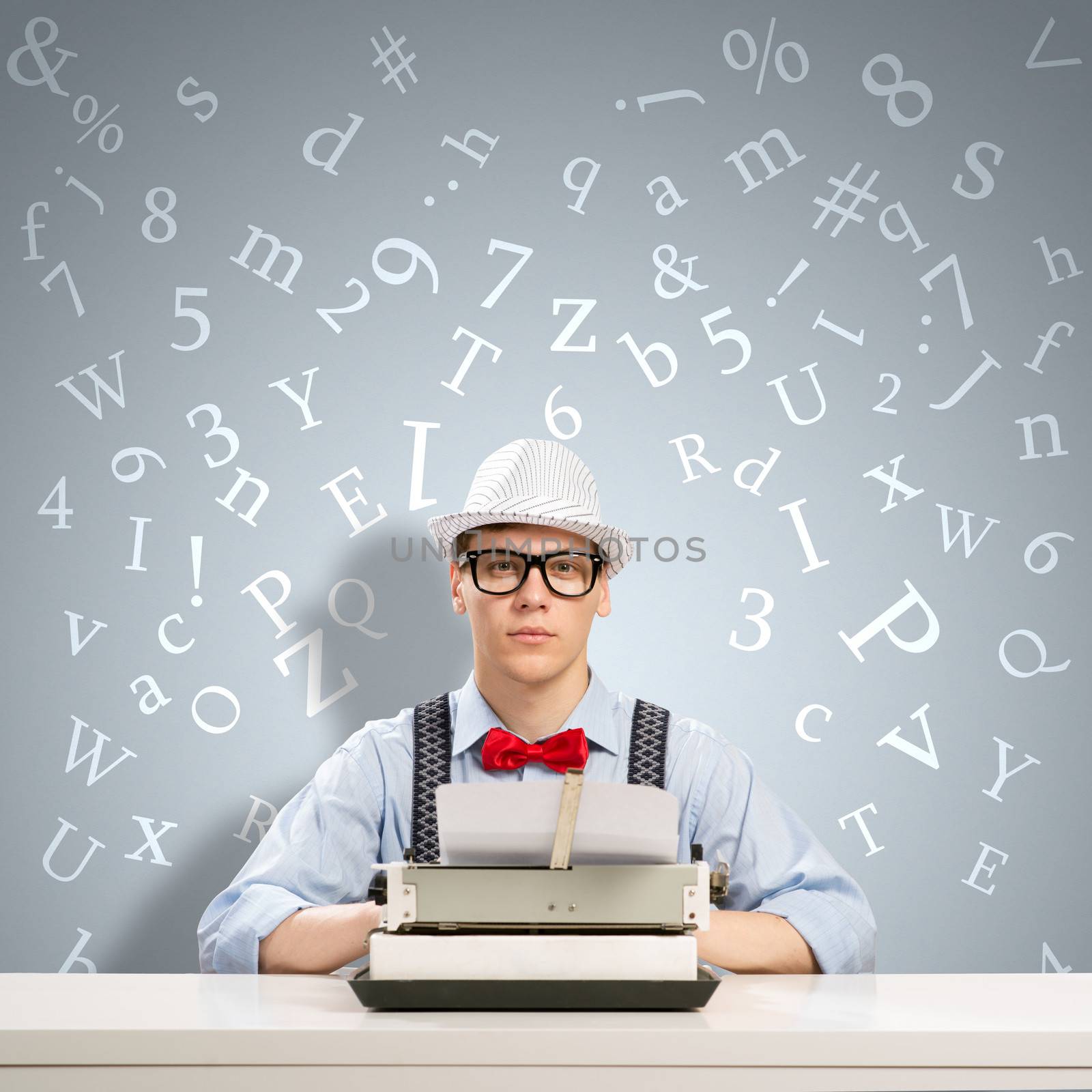 image of a young journalist, sitting at the table for a typewriter