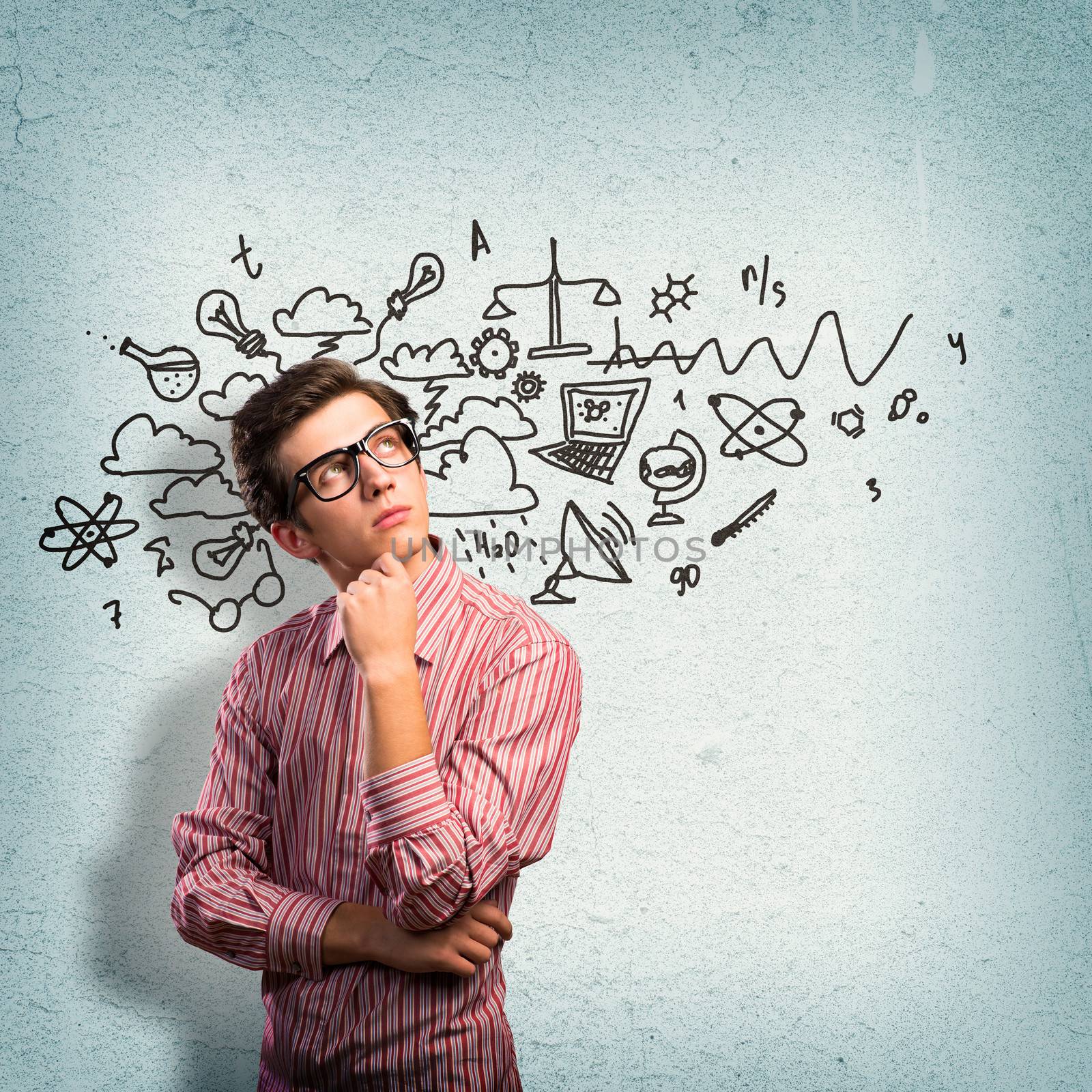 young man scientist in glasses thinking. next to it various painted symbols