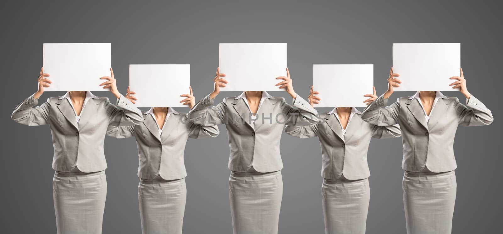 image of a businesswomen standing in a row, held in front of a blank poster