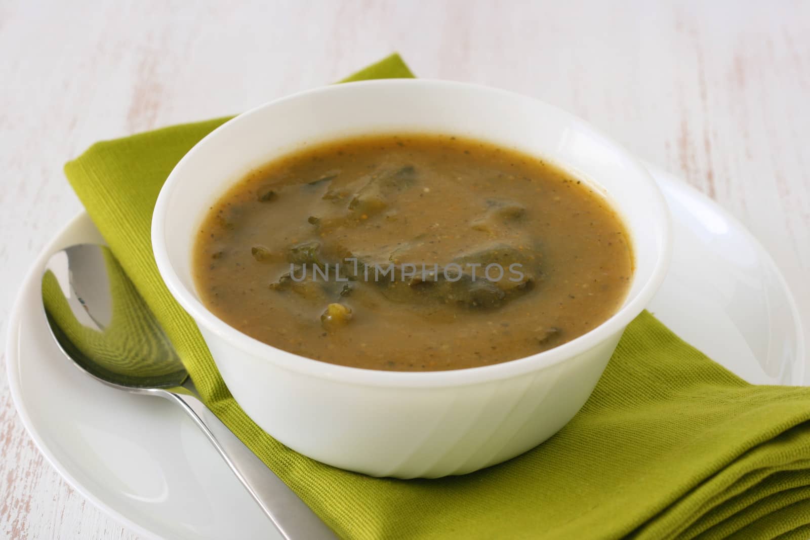 spinach soup in white bowl