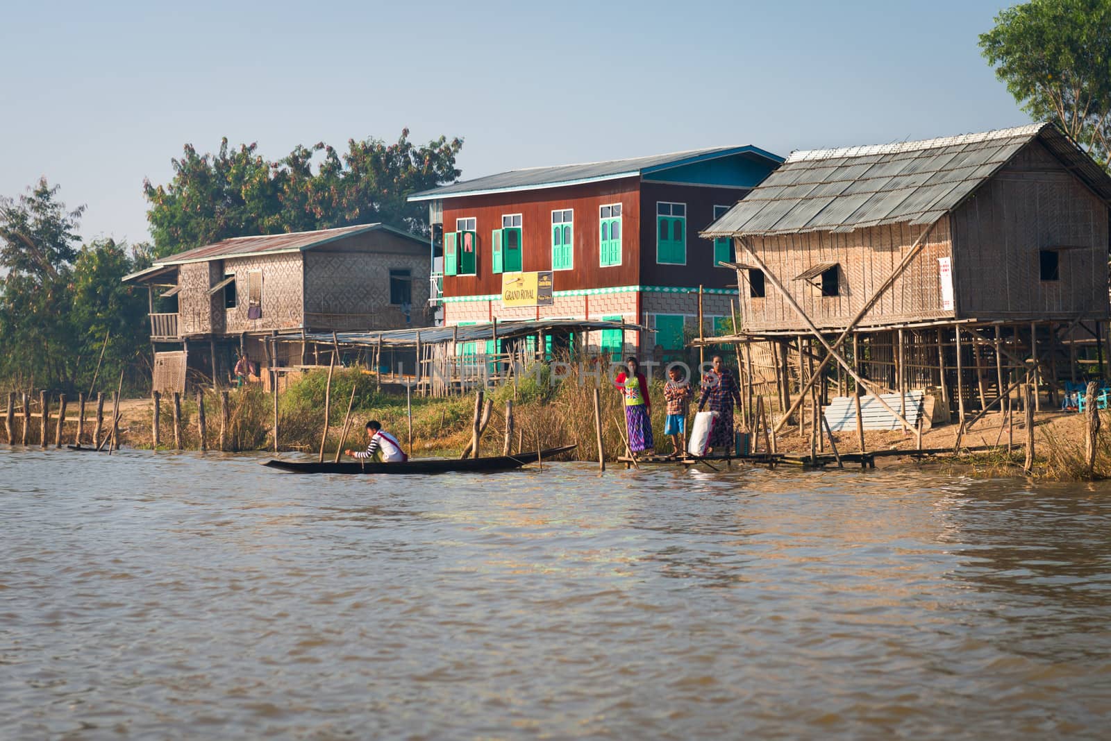 Traditional stilts house in water under blue sky by iryna_rasko