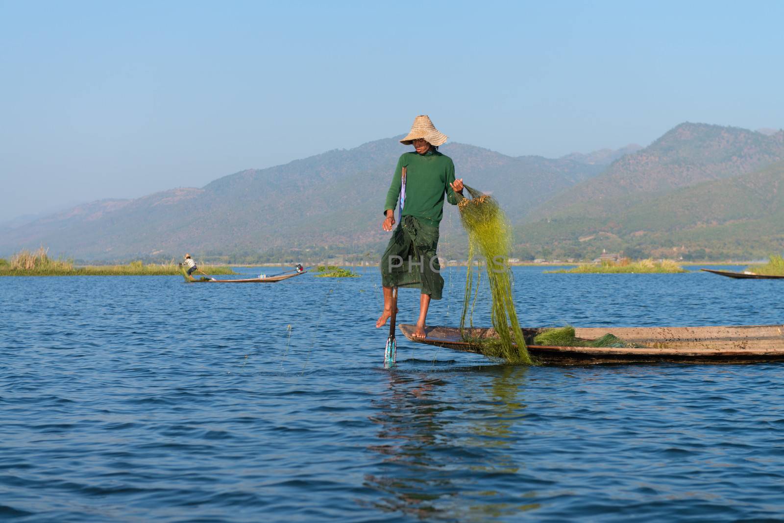 Unique leg rowing style and fishing in Burma by iryna_rasko