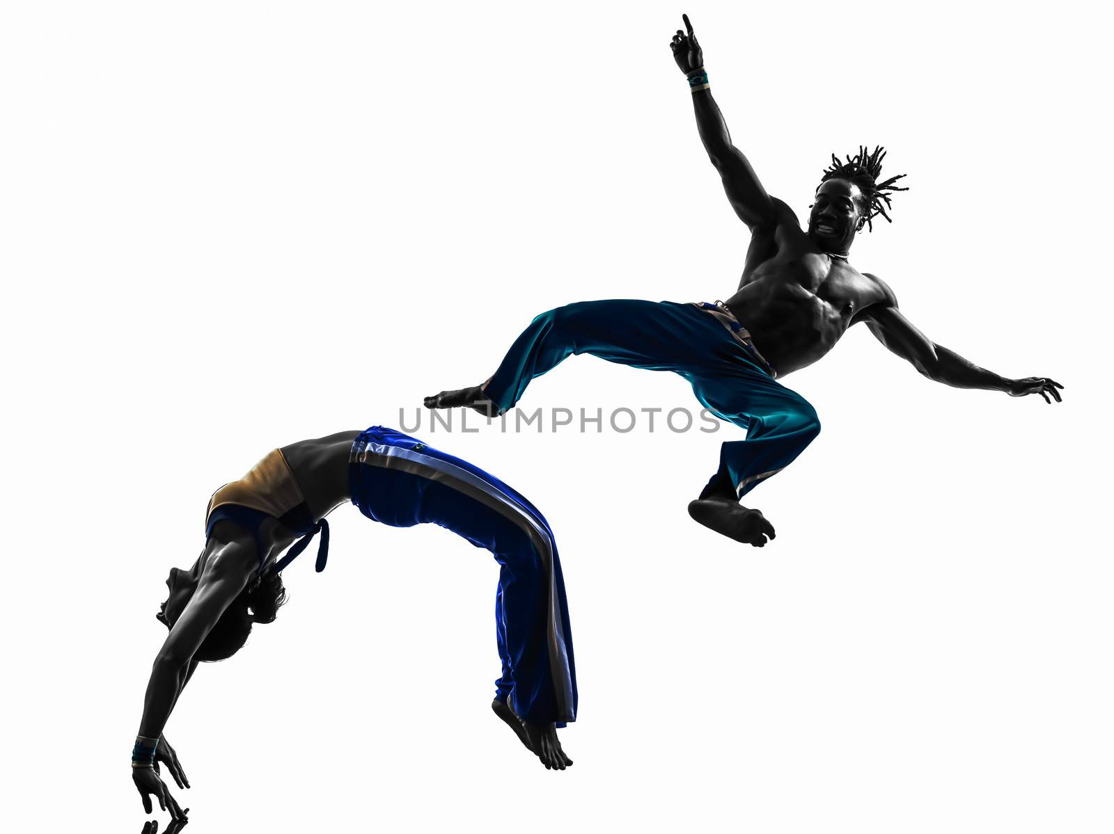 two people couple capoeira dancers dancing in silhouette studio isolated on white background