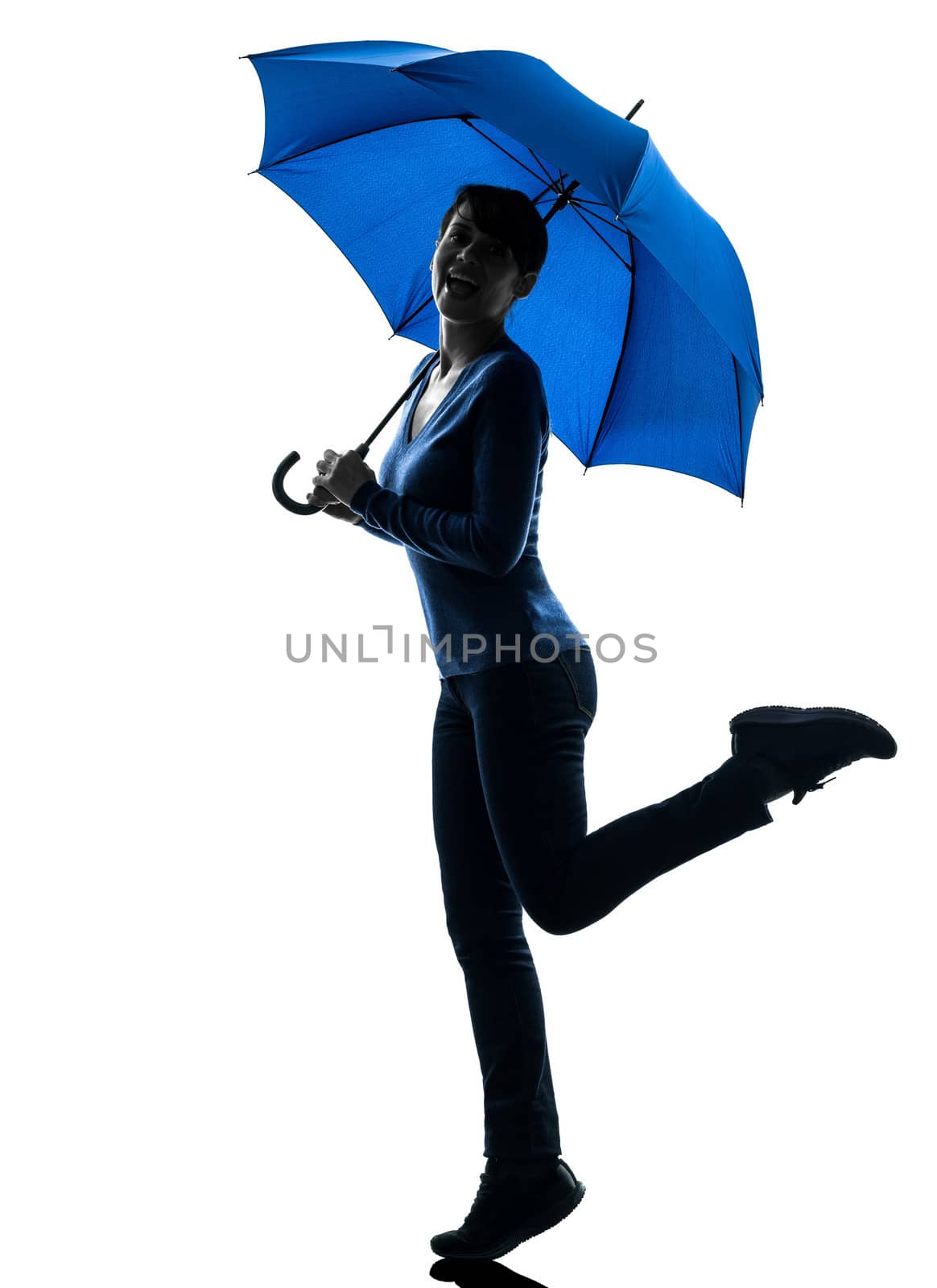 one caucasian woman happy holding umbrella in silhouette studio isolated on white background