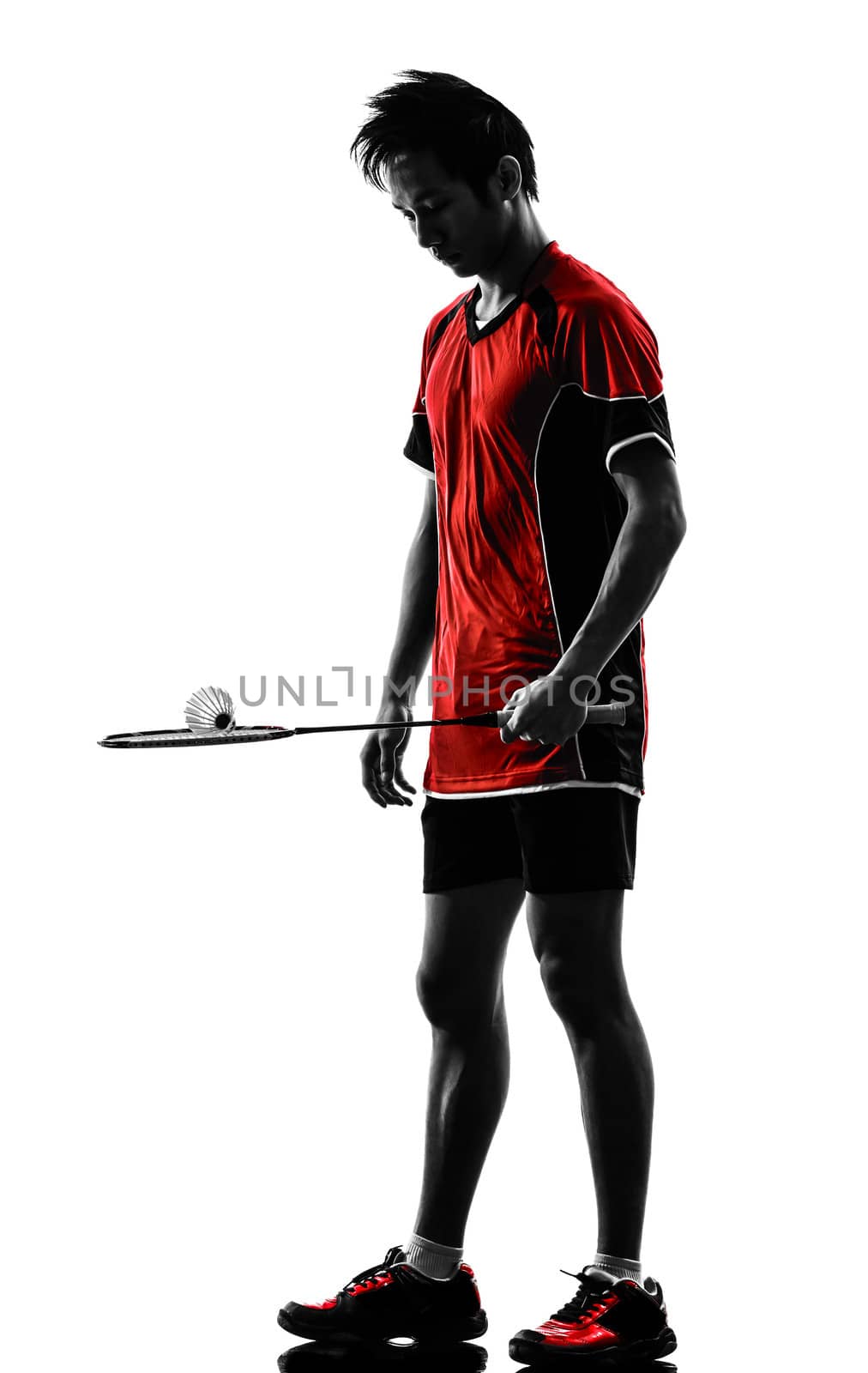 one asian badminton player young man  in silhouette isolated white background