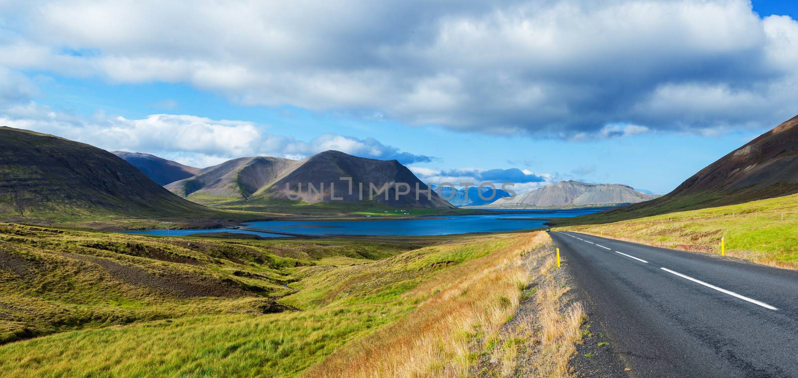Curve Road to sea lagoon at Western Iceland. Panorama.