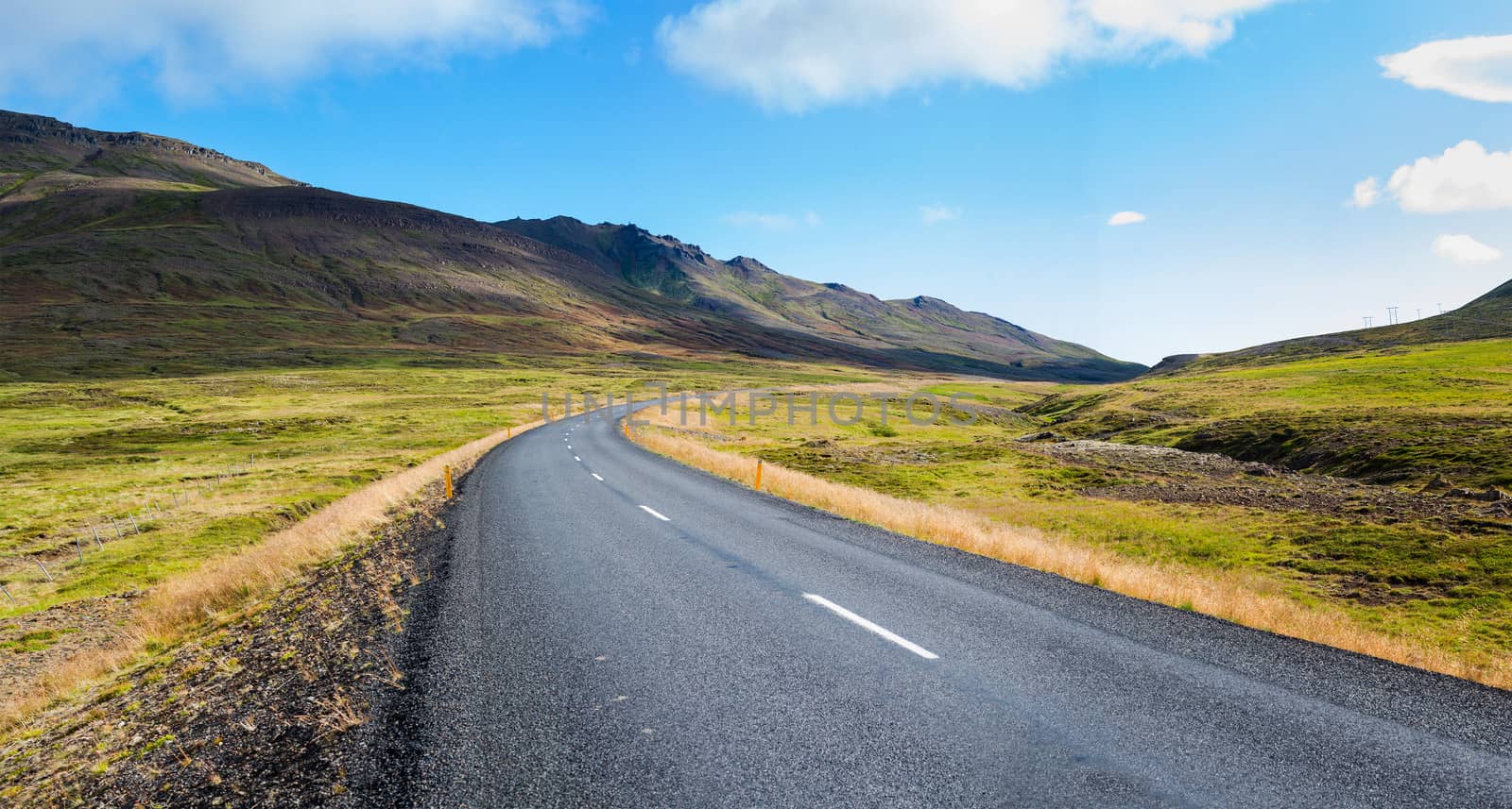 Highway through Iceland landscape at sunny day. Horizontal shot