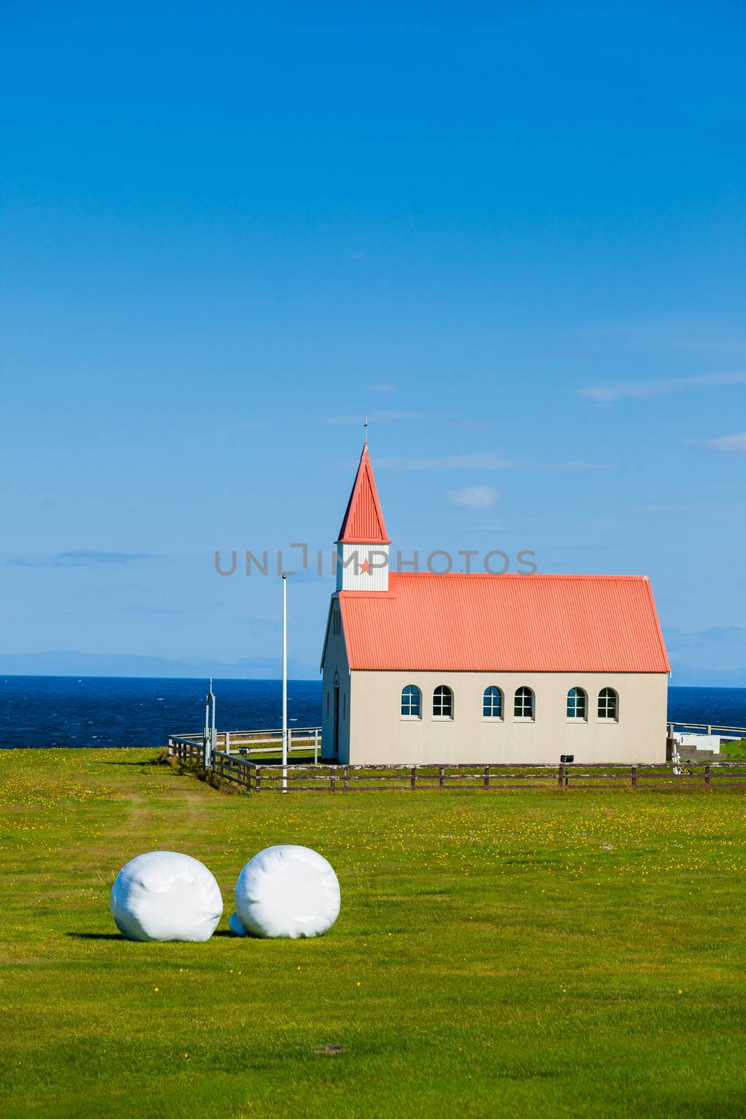 Typical Rural Icelandic Church under a blue summer sky. Vertical shot